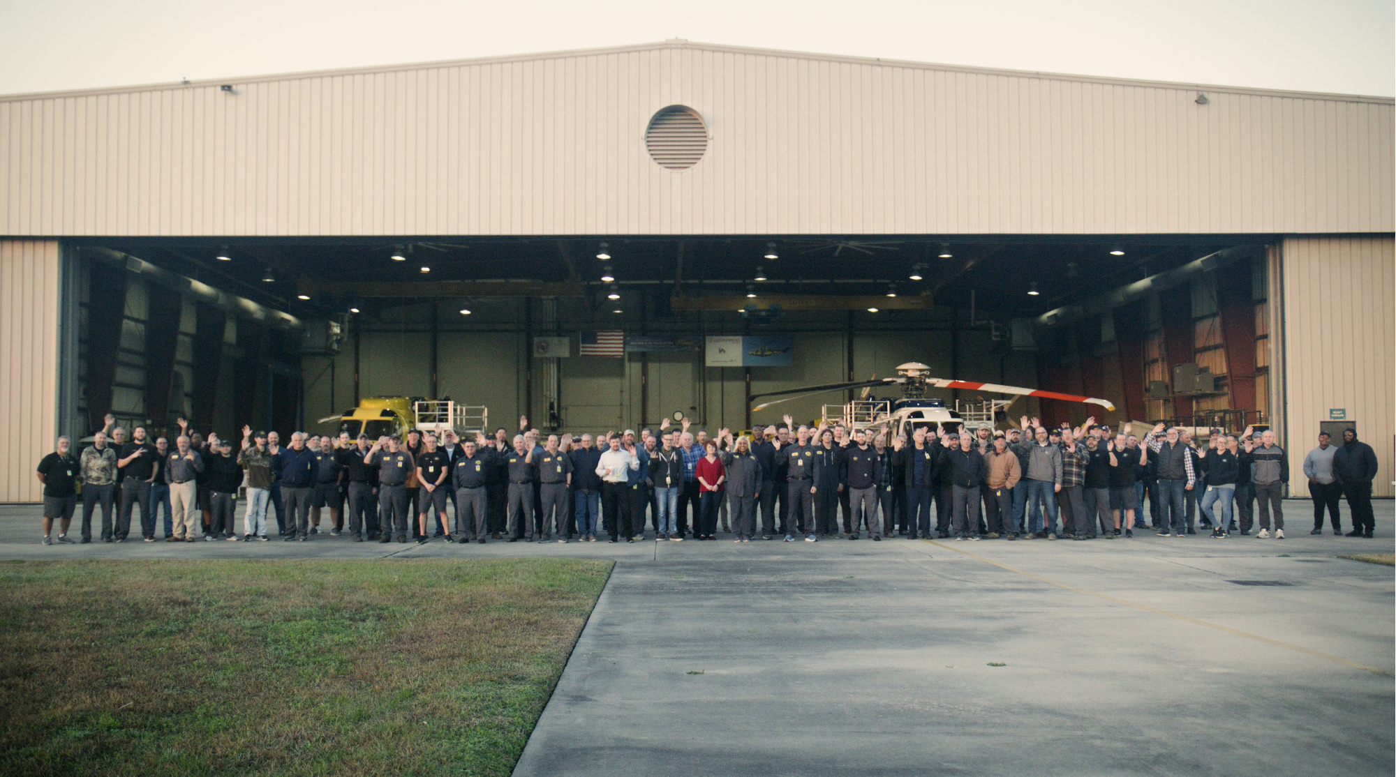 PHI MRO Services employees pose for photo outside of heavy hangar